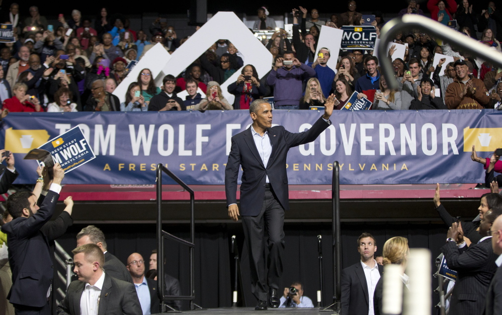 President Obama walks on stage at a Philadelphia rally Sunday for gubernatorial candidate Tom Wolf, who is trying to unseat Republican Gov. Tom Corbett.