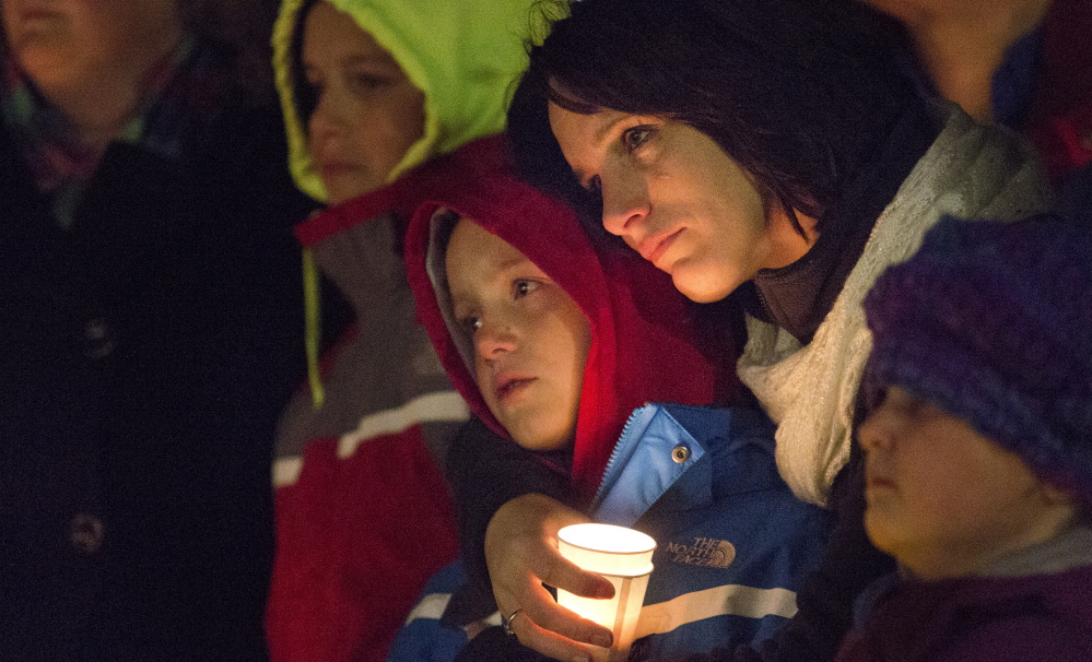 asdfl;kj... CORNISH, ME - NOVEMBER 3: Laura Gerry of Porter holds her son, Dylan Capano, 8, close to her as they comfort each other during a vigil that was held at Call’s Shop ‘n Save on Route 25 in Cornish Monday evening, November 3, 2014, for the victims of a car crash that killed two teenagers in Hiram early Saturday morning. Andrew Stanley, 18, of Porter, died at the scene, and Isaac Moore, 19, of Parsonsfield, died at Maine Medical Center. (Photo by Gabe Souza/Staff Photographer)