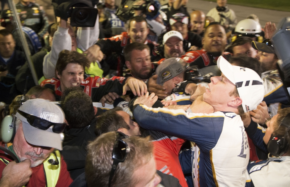 Brad Keselowski, right, is punched during a fight after the NASCAR Sprint Cup Series auto race at Texas Motor Speedway in Fort Worth, Texas, Sunday. The crews of Jeff Gordon and Keselowski fought after the race.