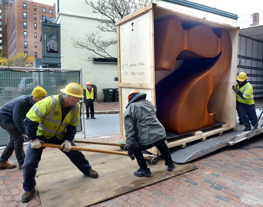 Workers get ready to install the “Seven” sculpture by Robert Indiana outside of the Portland Museum of Art. “This is a public announcement that 7 Congress Square will always be a place for art,” the chief curator says