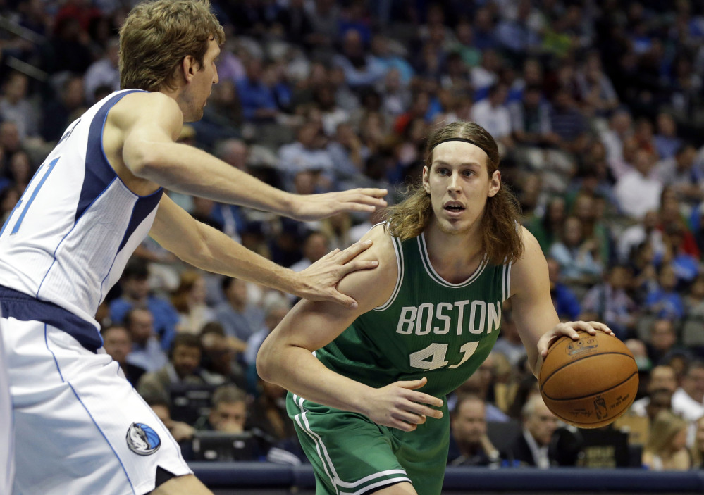 Boston Celtics center Kelly Olynyk drives against Dallas Mavericks forward Dirk Nowitzki in the first half of Monday night’s game in Dallas. The Celtics trailed by 31 points in the second quarter before closing the deficit to three in the last minute of the game.
