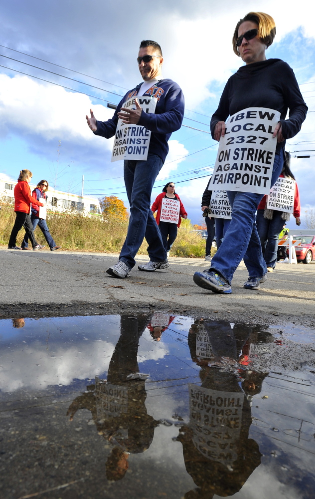 Striking workers march on the FairPoint Communications location on Davis Farm Road in Portland on Oct. 30.