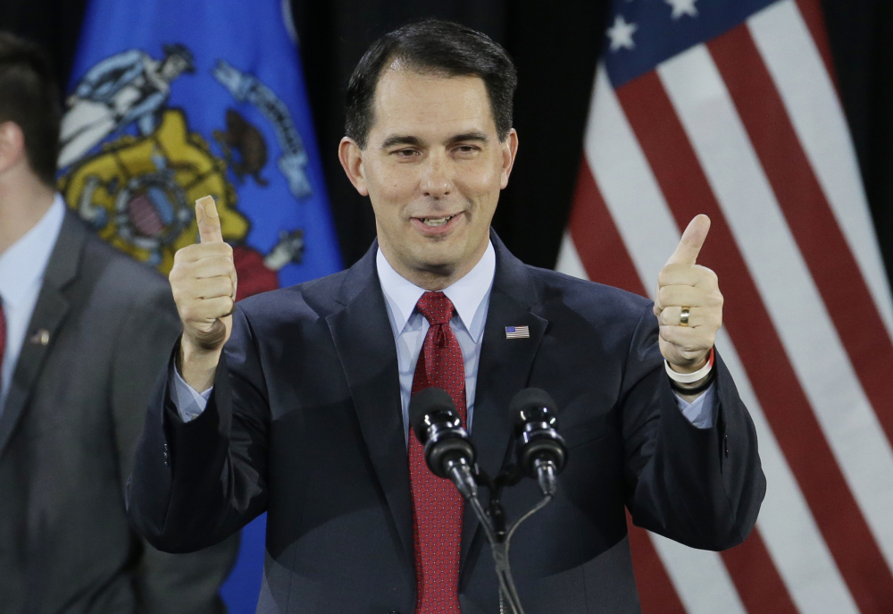 Wisconsin Republican Gov. Scott Walker gives a thumbs up as he speaks at his campaign party Tuesday, in West Allis, Wis. Walker defeated Democratic gubernatorial challenger Mary Burke.