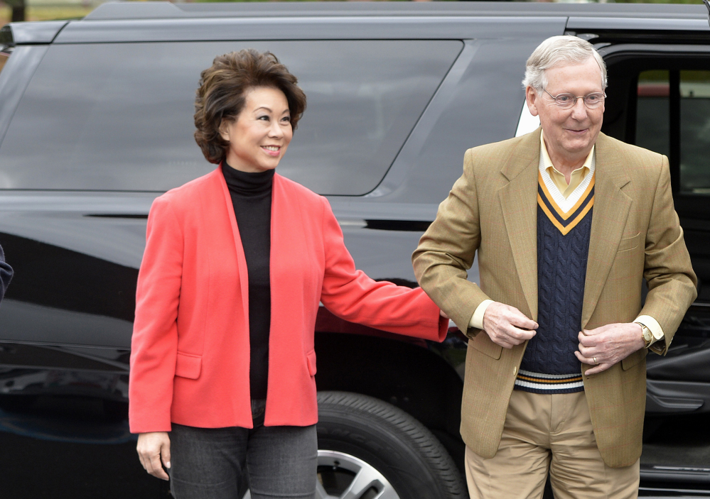 Senate Minority Leader Mitch McConnell of Kentucky and his wife, Elaine Chao, arrive at Bellarmine University Louisville, Ky., Tuesday, to cast their votes.