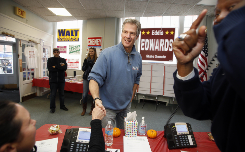 New Hampshire Republican Senate candidate Scott Brown greets volunteers on election day from the Republican field office, Tuesday, Nov. 4, 2014, in Dover, N.H. Brown is trying to unseat incumbent U.S. Sen. Jeanne Shaheen.  (AP Photo/Jim Cole)
