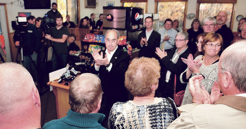 Bruce Poliquin, center, acknowledges supporters during a press conference Wednesday at the Oakland House of Pizza after winning Maine’s 2nd District Congressional seat.