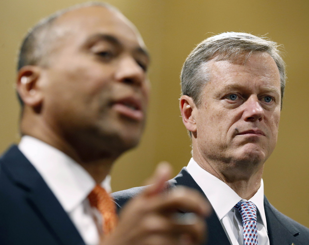 Gov. Deval Patrick, left, stresses the importance of a smooth transition for the incoming administration of Republican Charlie Baker, right, who narrowly defeated Martha Coakley.