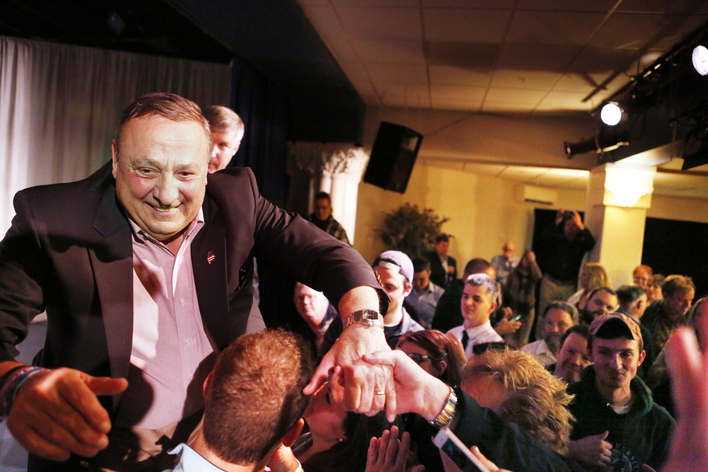 Gov. Paul LePage greets supporters after his acceptance speech early Wednesday during his campaign gathering at the Franco American Heritage Center in Lewiston.