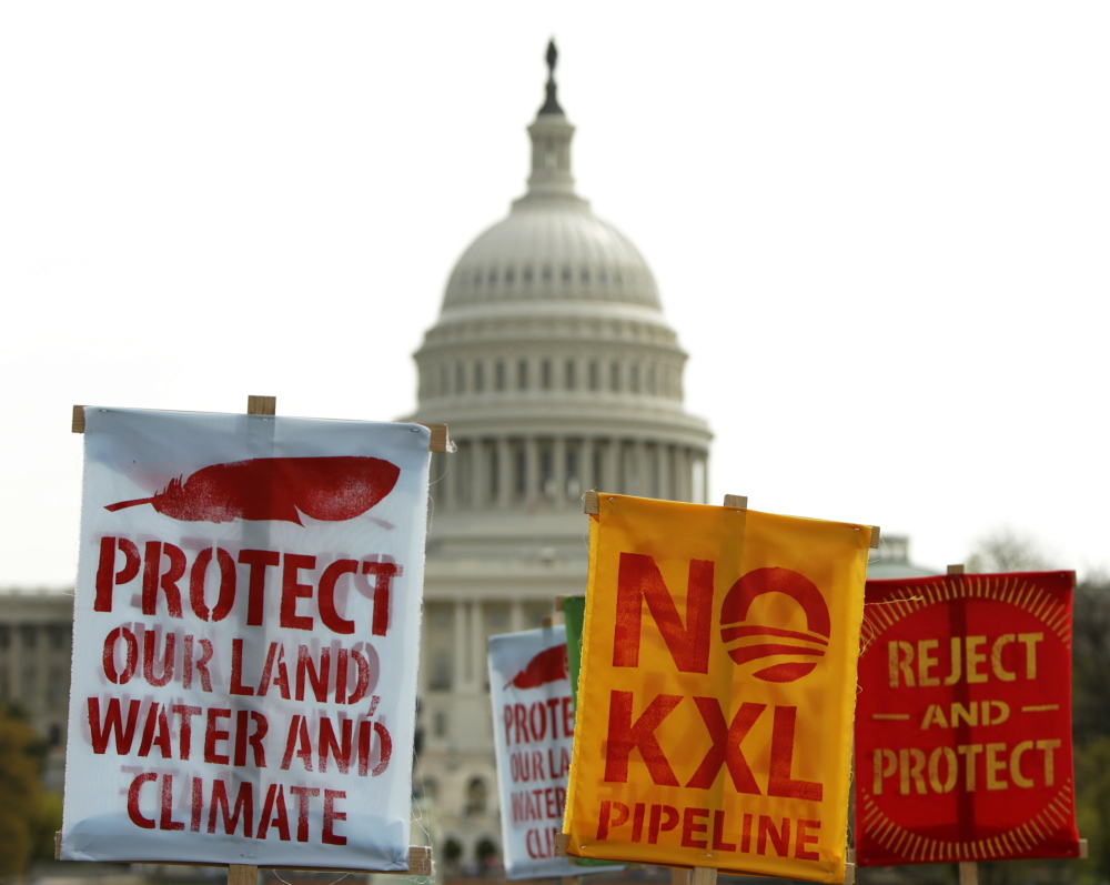 Signs in front of the U.S. Capitol protest the Keystone XL pipeline earlier this year. One election analyst suggested the Obama administration might even approve the pipeline before January, “to rob the GOP of an early-session victory lap.”