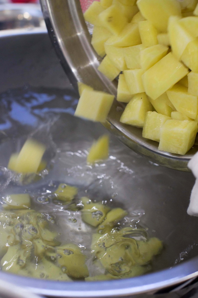 After the potatoes are cooked the first time, they are cooled down in an ice-water bath.