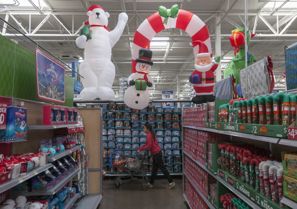 The holiday shopping season is underway, including at this Wal-Mart in Dallas. One retail strategist has forecast that average household spending this season will be $684, down from $735 in 2013. Another, however, said overall spending will be up by 4.1 percent.