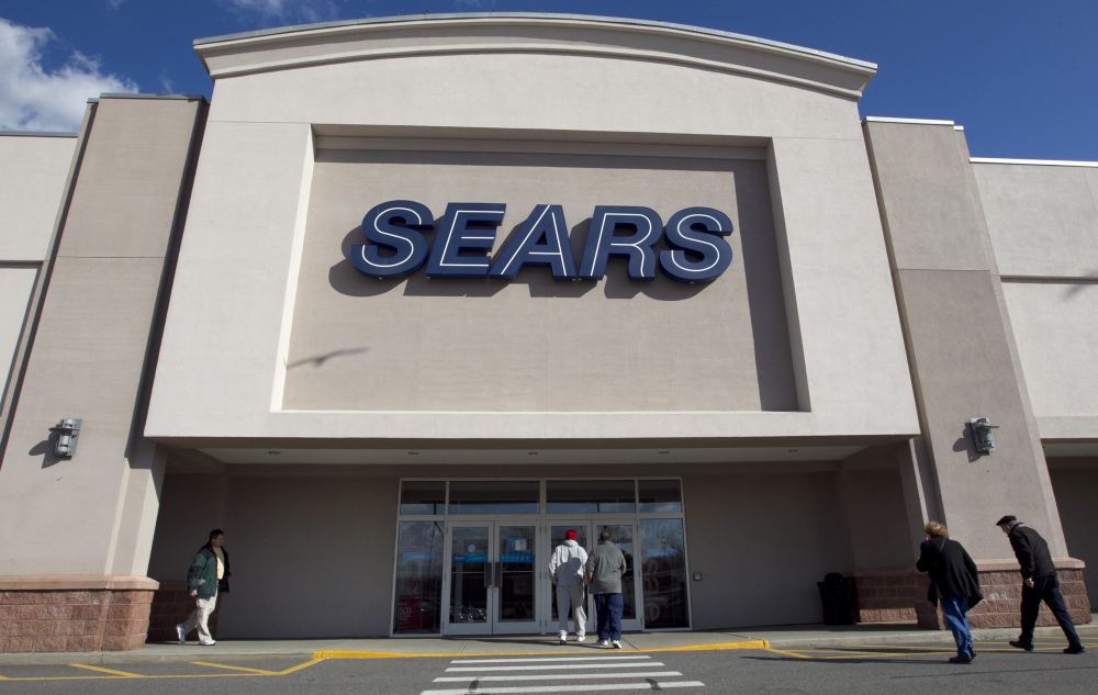 Shoppers enter a Sears department store in Dedham, Mass., in 2012. Sears Holdings stock skyrocketed on Friday.