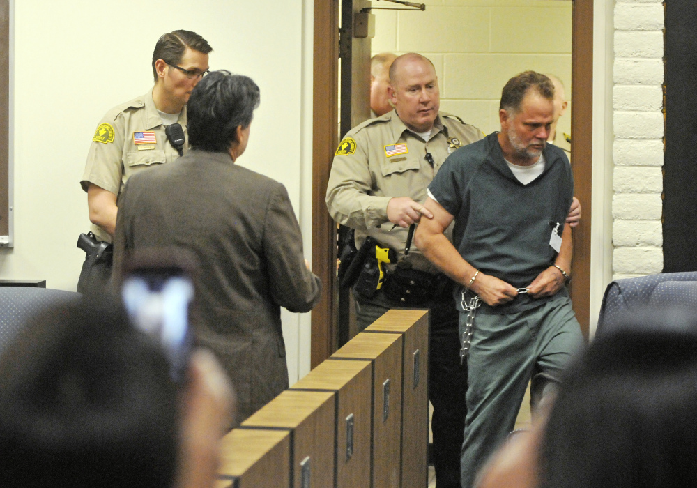 Charles “Chase” Merritt, 57, is led into court for an arraignment hearing at the the Victorville Courthouse on Friday in Victorville, Calif.