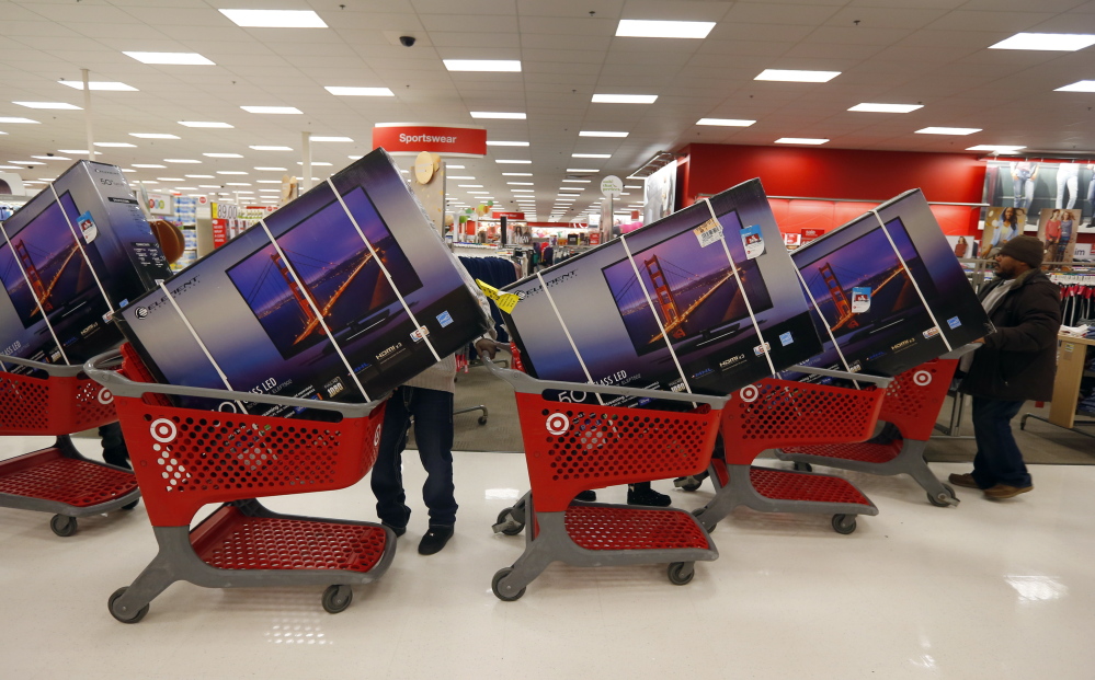 Thanksgiving Day shoppers line up with discounted TVs at a Chicago Target store last year.