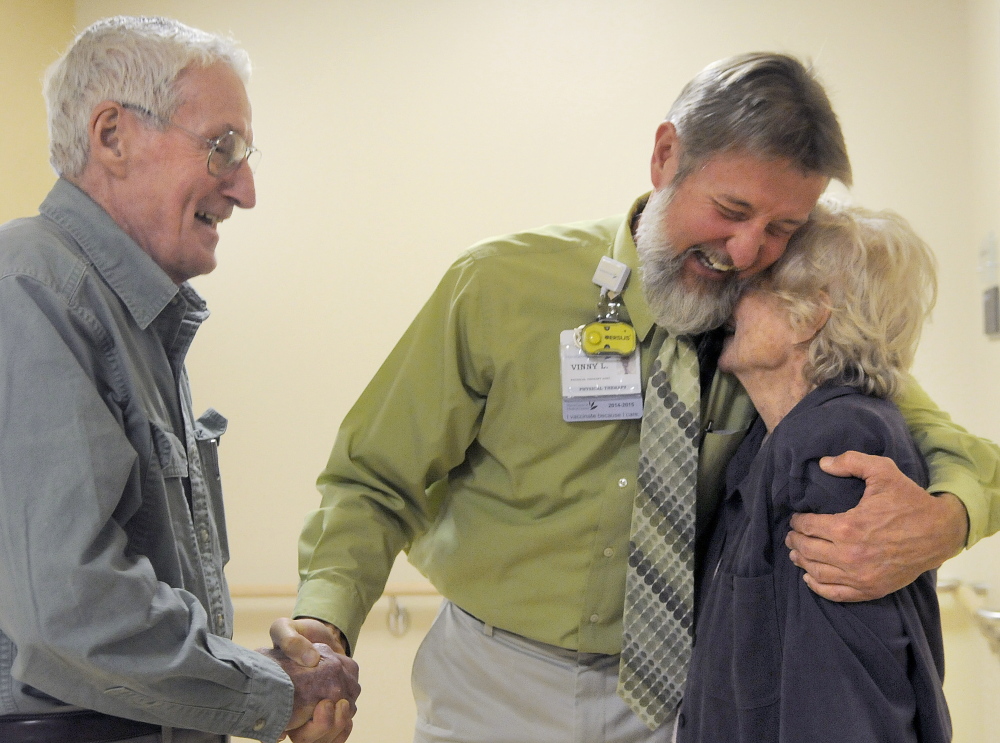 Physical therapist Vinny Lord hugs Anita Smart recently while shaking hands with her husband, Jack, in the rehabilitation facility at MaineGeneral Medical Center. Lord assisted Anita Smart in recovery from a stroke this spring. The Hallowell couple made a sizable donation to the hospital and wanted to thank the therapist for his care, Jack Smart said.