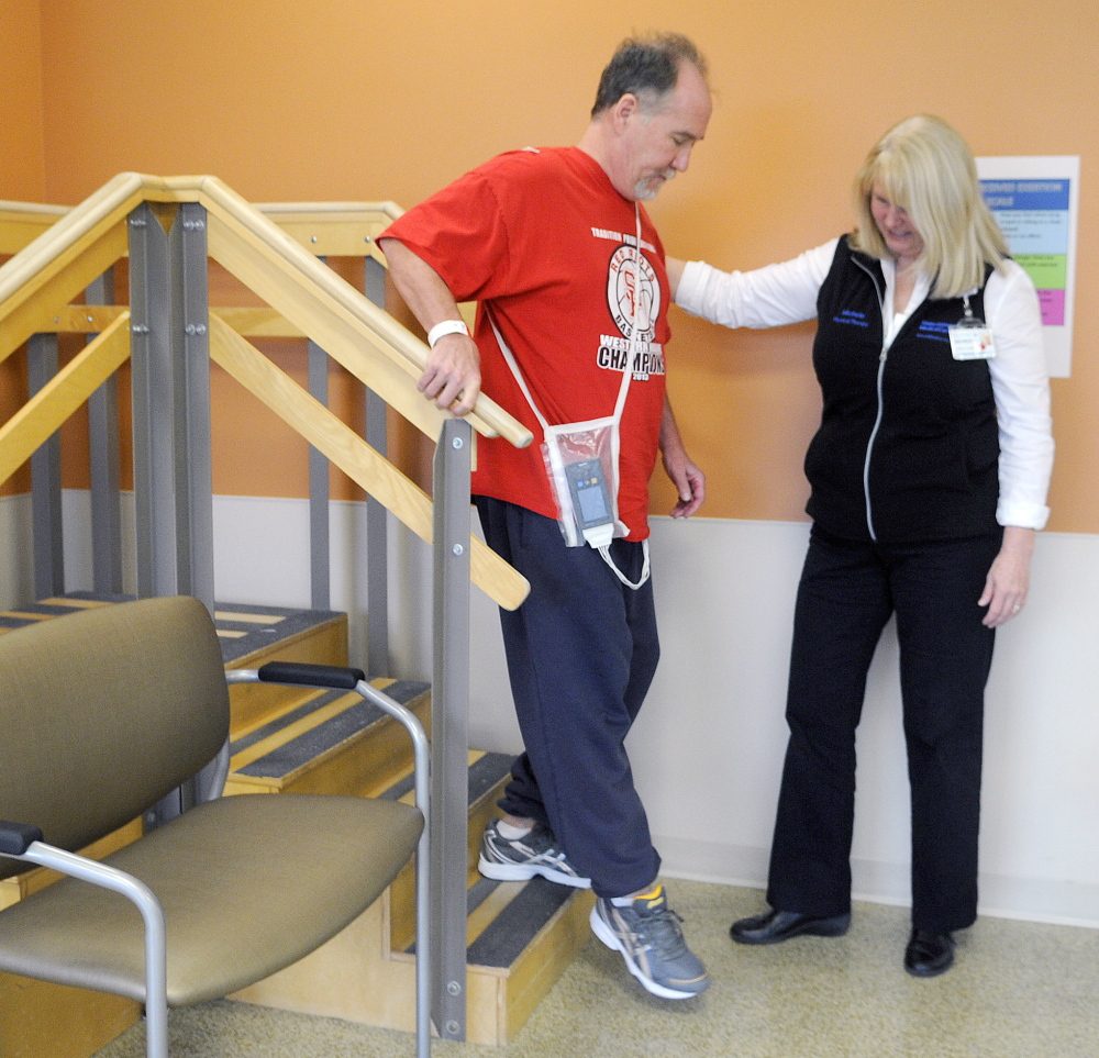 Jim Byrne practices steps with physical therapist Michele Walter in the long-term care and rehabilitation facility at MaineGeneral. The hospital is celebrating its first anniversary.