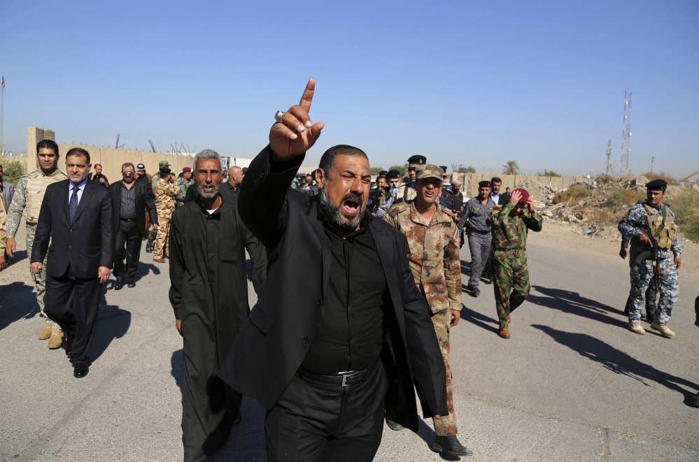 Mourners chant anti-Islamic State group slogans during the funeral procession of police Lt. Gen. Faisal Malik in Baghdad on Saturday. A suicide truck bomber targeting a senior police officer’s convoy in Iraq late Friday killed several people, including the ranking official, authorities said Saturday.