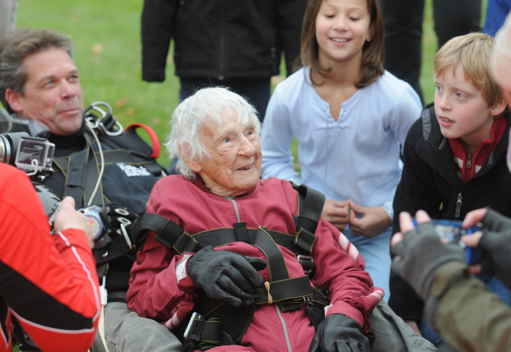 Eleanor “Nanny” Cunningham, with tandem master Dean McDonald, are welcomed by Cunningham’s friends and family after their skydive in Gansevoort, N.Y, on Saturday, a day after her 100th birthday. It was the third jump for Cunningham, who took up the sport when she was 90.