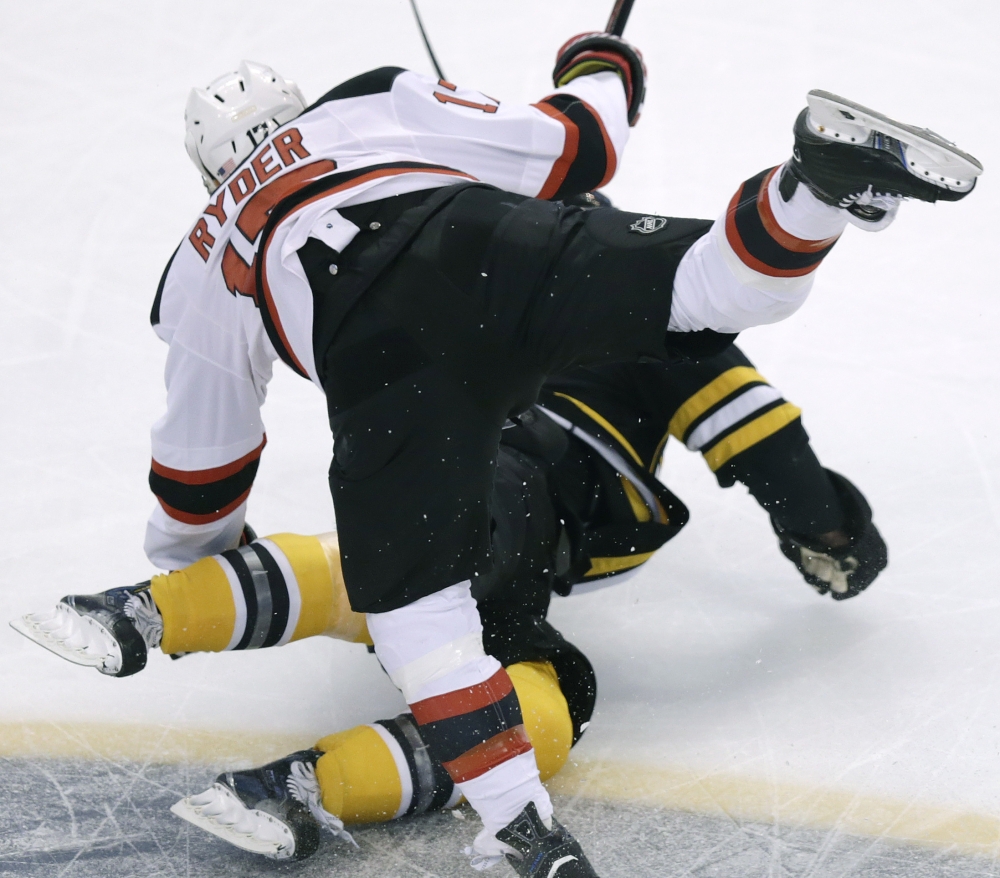 New Jersey right wing Michael Ryder heads for a tumble over Boston defenseman Dennis Seidenberg during the Bruins’ 4-2 win over the Devils on Monday at Boston. One highlight for the Devils: Jaromir Jagr scored his 708th goal, tying him with Mike Gartner for sixth on the NHL list.