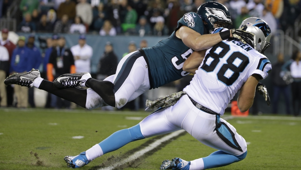 Carolina’s Greg Olsen, 88, is tackled by Philadelphia’s Casey Matthews after catching a pass in the first half of their game Monday in Philadelphia.