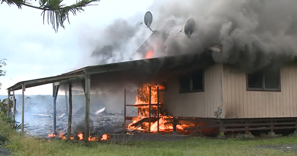 In this image from video provided by the County of Hawaii, lava flow from the Kilauea Volcano burns a residential structure Monday in Pahoa, Hawaii. A stream of lava set a home on fire Monday in a rural Hawaii town that has been watching the slow-moving flow approach for months. The home’s renters already had left the residence in Pahoa, the largest town in the Big Island’s isolated and mostly agricultural Puna district.