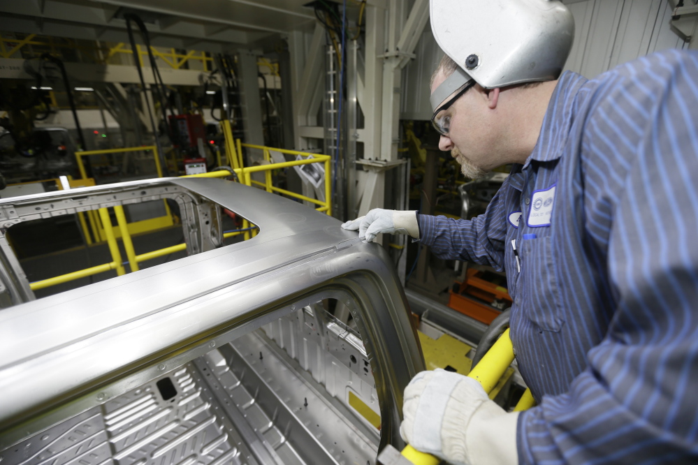 Ron Hudgin measures the roof line of the F-150 truck at the Rouge Truck Plant in Dearborn, Mich. It’s the automaker’s biggest bet in decades: an aluminum-sided F-150 that could set a new industry standard - or cost the company its pickup truck crown.