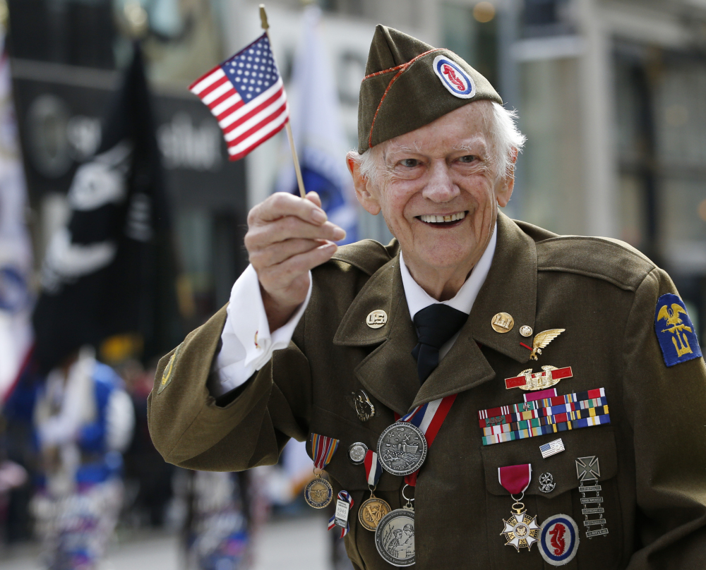 World War II veteran Frederick Carrier, 90, who says he helped liberate the Buchenwald concentration camp, marches up New York’s Fifth Avenue on Tuesday.