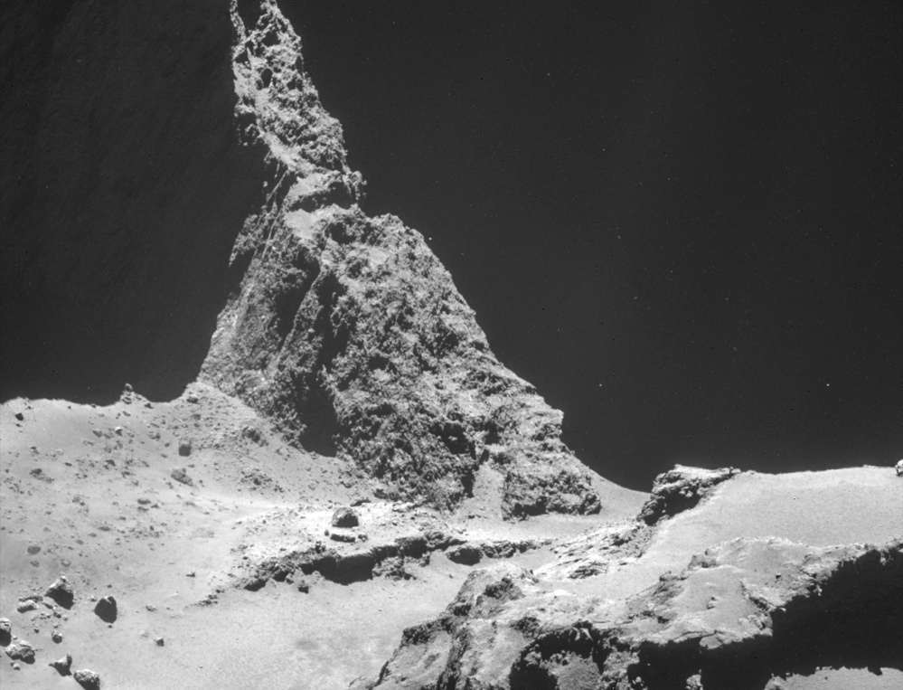 A photograph from the navigation camera on Rosetta shows a region of Comet 67P/Churyumov–Gerasimenko. The 2.5-mile wide comet is about 4.8 miles away in the photo.