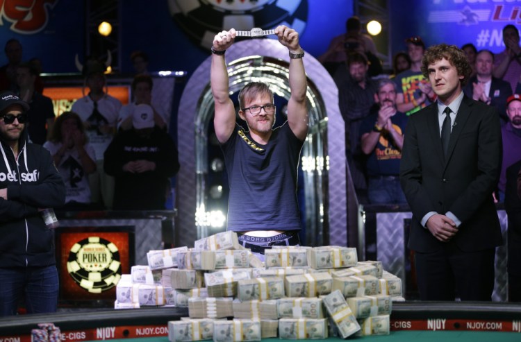 Martin Jacobson holds up the World Series of Poker main event bracelet after winning the tournament and its $10 million prize, Tuesday in Las Vegas.