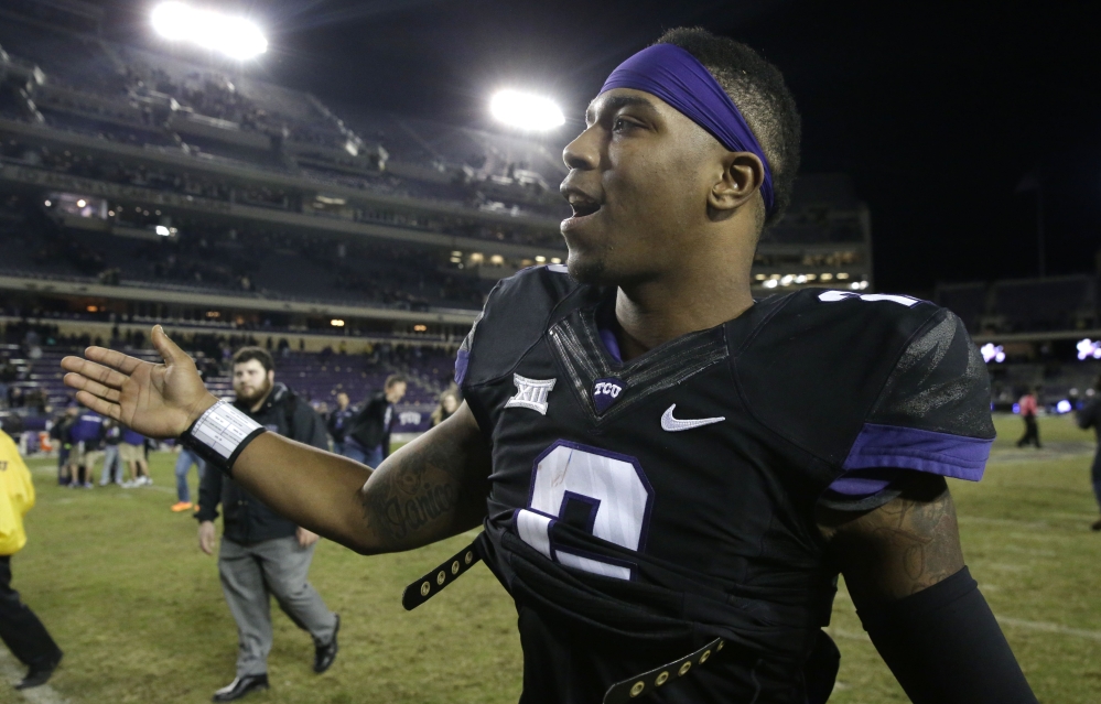 TCU quarterback Trevone Boykin is congratulated as he walks off the field after an NCAA college football game against Kansas State on Saturday in Fort Worth, Texas.