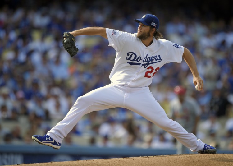 Clayton Kershaw, seen pitching against the St. Louis Cardinals in the NL Division Series last month, was the unanimous winner of his third Cy Young Award after leading the majors in victories and ERA and throwing a no-hitter. Kershaw earned the honor for the second year in a row.