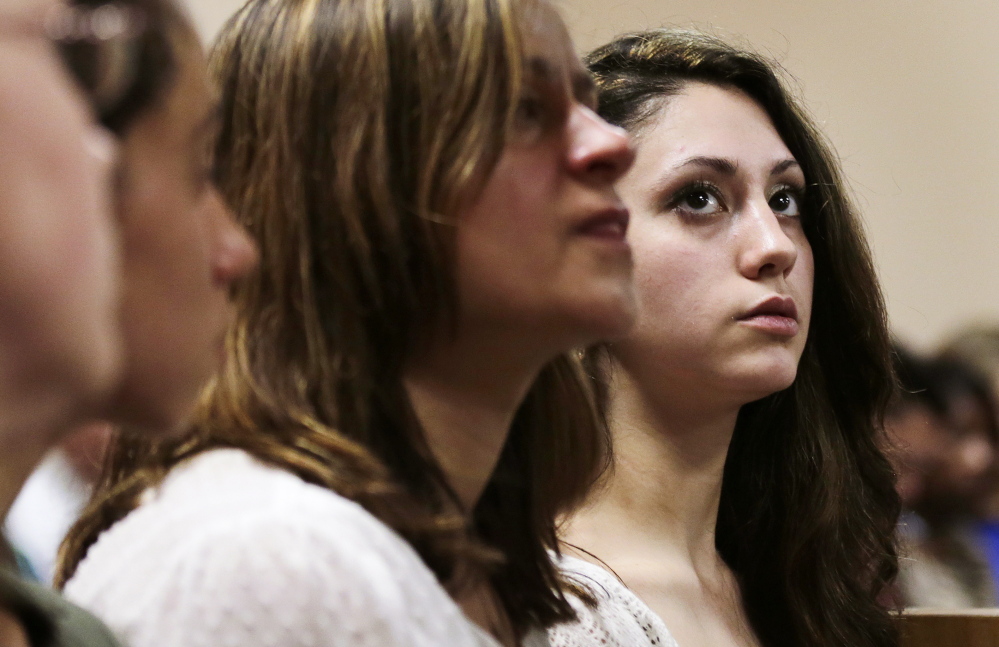 Abigail Hernandez, right, listens as her mother, Zenya Hernandez, center, speaks prior to the arraignment of Nathaniel Kibby, 34, of Gorham, N.H., at Conway District Court in Conway, N.H., on July 29.