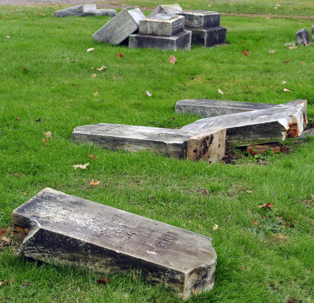 Vandals toppled dozens of headstones at Riverside Cemetery in Augusta sometime Tuesday night or Wednesday morning, police said.