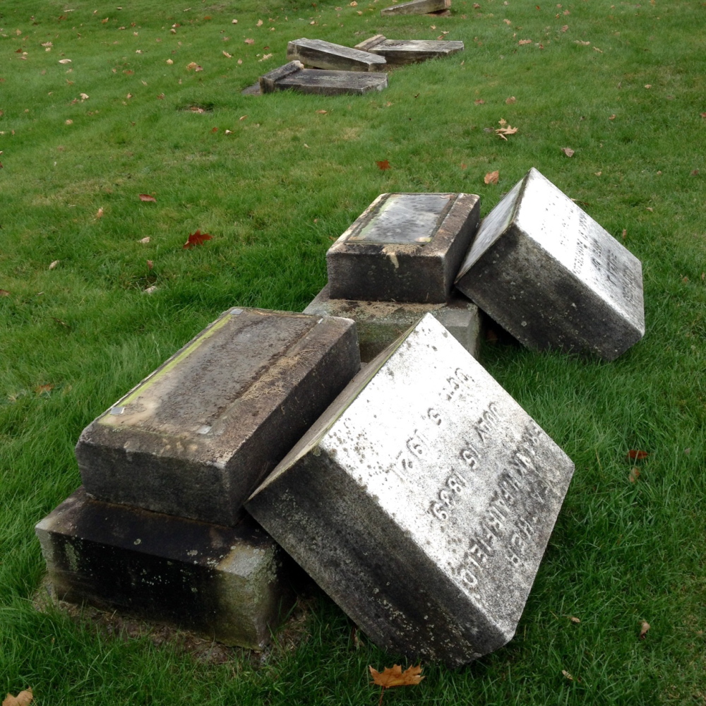 Vandals toppled dozens of headstones at Riverside Cemetery in Augusta sometime Tuesday night or Wednesday morning, police said.