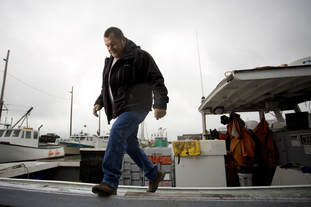 Chief Frederick Moore III of the Pleasant Point reservation steps off his fishing boat in Eastport.