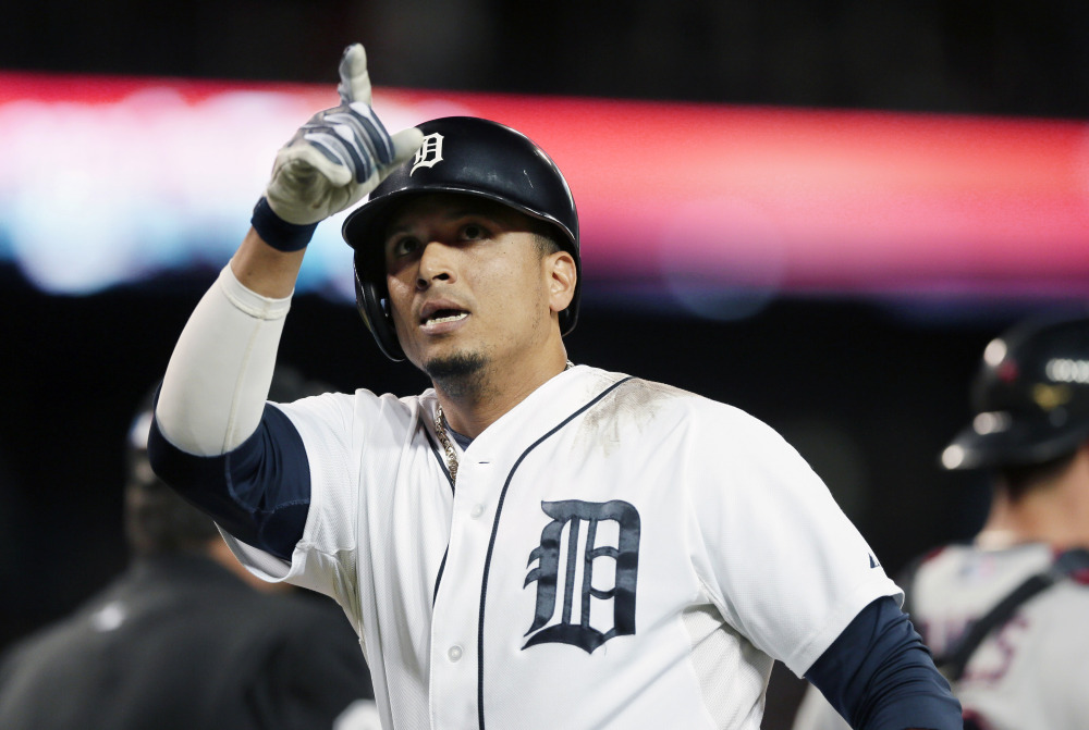 Detroit Tigers designated hitter Victor Martinez points to the stands after his solo home run against the Cleveland Indians in Detroit on Sept. 13. A person with knowledge of the deal says the Tigers have agreed to a $68 million, four-year contract with Martinez.  The Associated Press