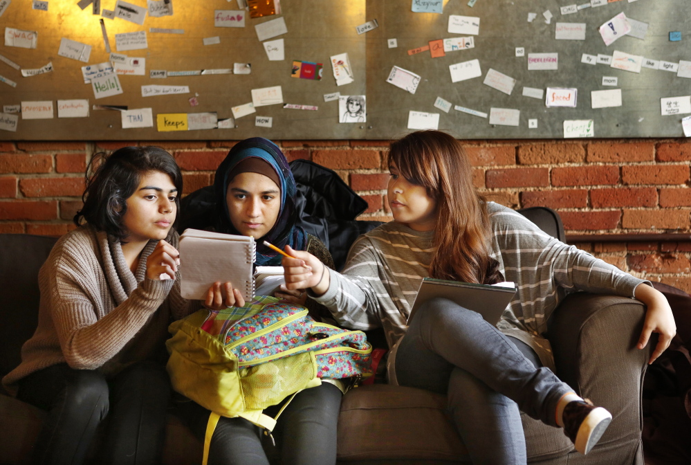 From left, Elahe Seddiqi, Maryam Abdullah and Mary Khadim look over a story that Seddiqi is working on at The Telling Room in Portland on Thursday. Seddiqi is a sophomore at Portland High School, Abdullah is a junior at Portland High and Khadim is a freshman at Deering High School. The Telling Room works with students in 50 schools in Maine.