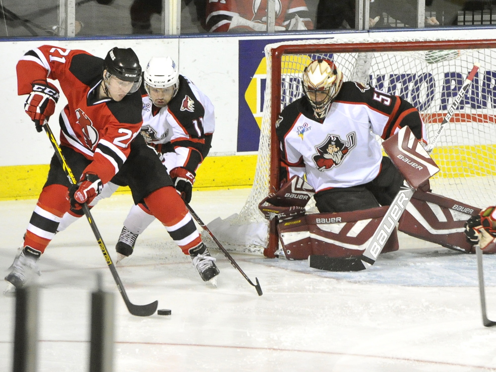 Albany’s Graham Black tries to score as Portland’s Francis Wathier and goalie Mike McKenna make the stop in the Pirates’ loss to the Albany Devils on Friday night at the Cross Insurance Arena in Portland.
