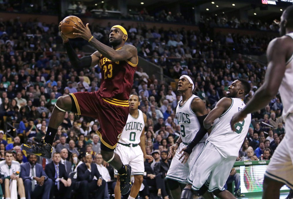 Cleveland’s LeBron James drives through the Boston Celtics’ defense during the second half of Friday night’s game in Boston. James scored a season-high 41 points as the Cavaliers beat the Celtics, 122-121.