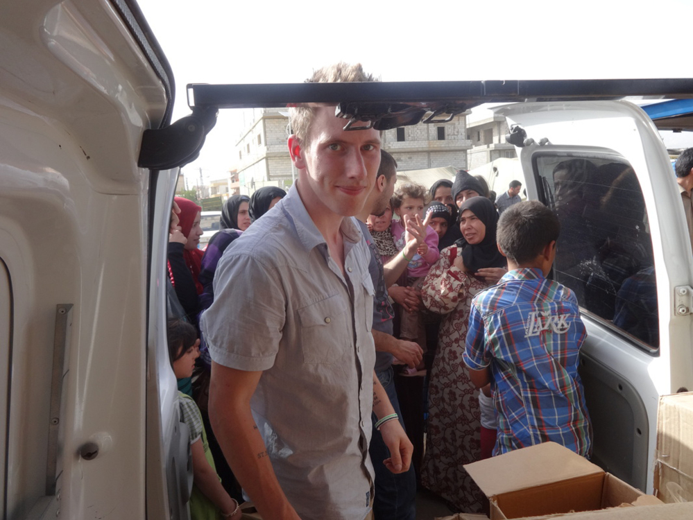 This undated photo provided by the Kassig Family shows Peter Kassig delivering supplies for Syrian refugees. A new graphic video purportedly produced by Islamic State militants in Syria released Sunday claims U.S. aid worker Kassig was beheaded.