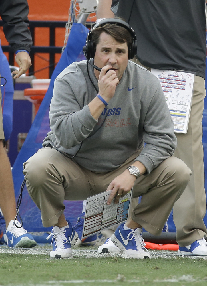 Florida Coach Will Muschamp watches from the sideline as South Carolina is about to score a touchdown to tie the game and send it in to overtime late in the second Saturday in Gainesville, Fla. A person close to the situation says Sunday that Muschamp is stepping down as coach