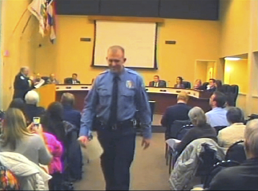 Officer Darren Wilson attends a city council meeting in Ferguson, Mo. His shooting of 18-year-old Michael Brown on Aug. 9 is just one of many cases that lead to questions about the use of lethal force by law enforcement personnel.