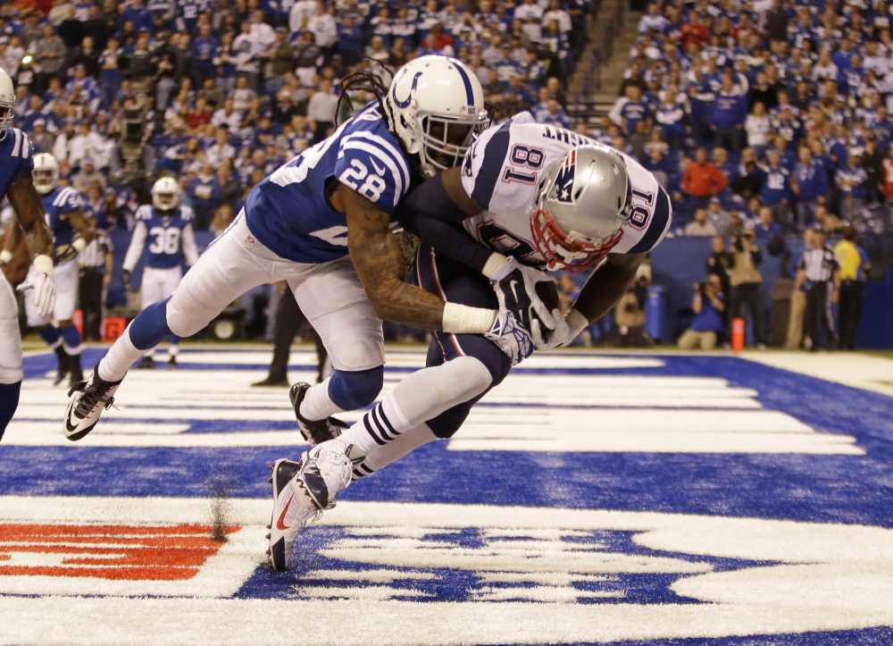 New England Patriots tight end Timothy Wright, right, makes a catch for a touchdown in front of Indianapolis Colts cornerback Greg Toler in the second half Sunday in Indianapolis.