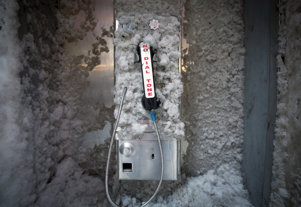 Looking like the relic from another era that it really is, a disused pay phone is covered by snow in New York’s Times Square earlier this year. But it may not be ready for deep-freeze.