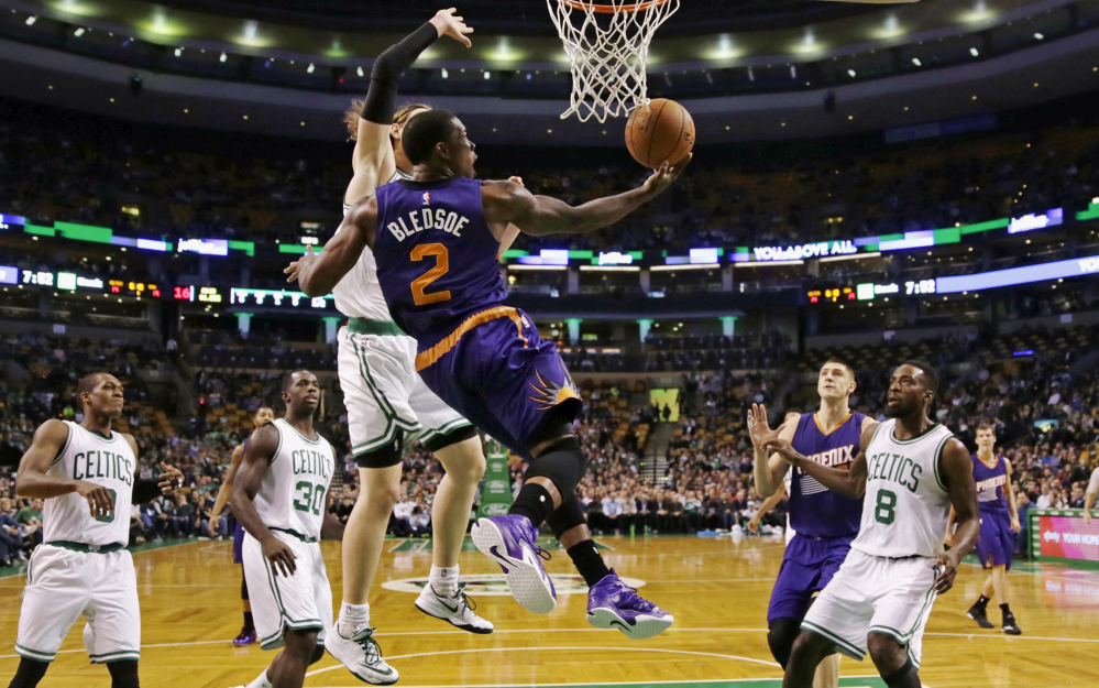 Phoenix Suns guard Eric Bledsoe takes a reverse lay-up after passing the Boston Celtics on a drive to the basket during the first quarter of Monday night’s game in Boston. Bledsoe made the game-winning play for the Suns in the last minute.