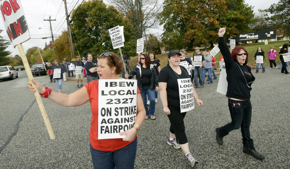 Renee Dugas, center, a FairPoint employee for 17 years, and other workers walk the picket line on the first day of the strike nearly five weeks ago in front of the company’s Maine headquarters at 5 Davis Farm Road in Portland.