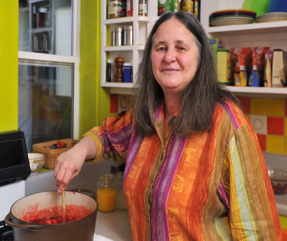 Author Ellen Cooney makes cranberry sauce at her home in Phippsburg. 