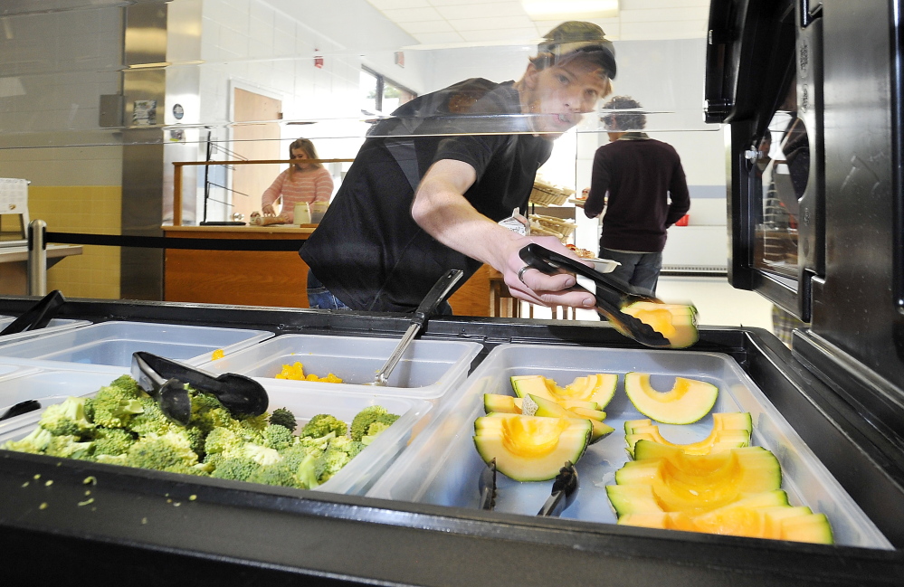 Corey Reddy, a senior, adds fruit to his meal at Kennebunk High School .