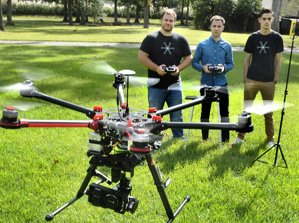 Paul Charbonnet, left, of Atmosphere Aerial in Louisiana, demonstrates a drone aircraft. Drones have become very popular for aerial photography, but have also spurred debate about the safety and regulation of these aircraft.
