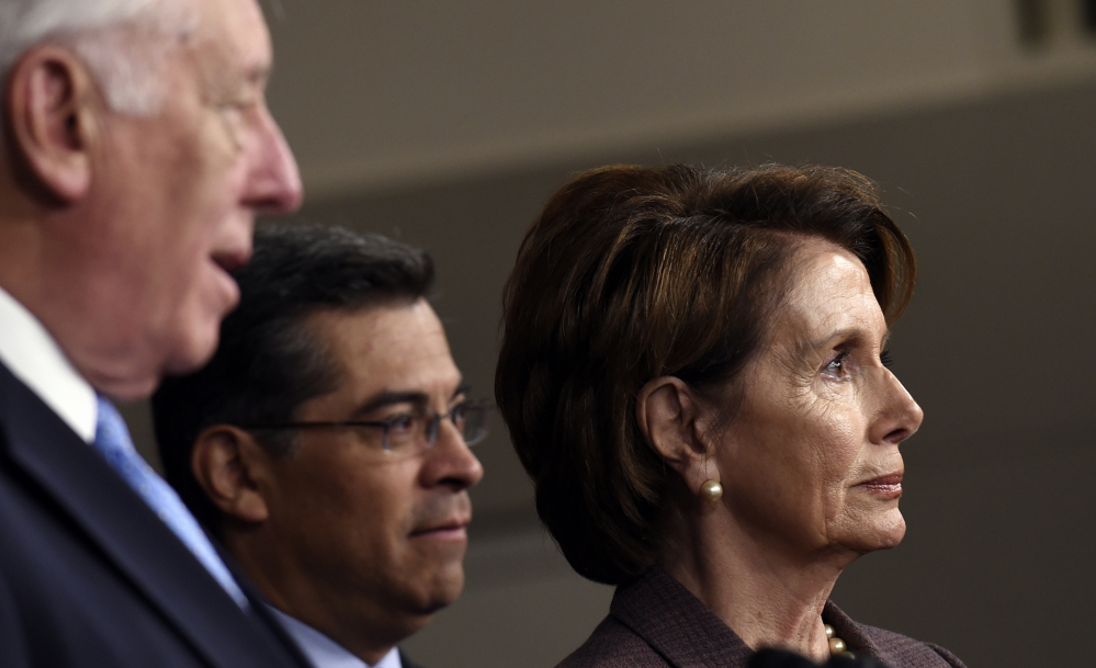 House Minority Leader Nancy Pelosi of Calif., right, and Chairman of the Democratic Caucus Rep. Xavier Becerra, D-Calif., center, listen as House Minority Whip Steny Hoyer of Md., left, speaks during a news conference Tuesday on Capitol Hill in Washington, to introduce the Democratic leadership team for the 114th Congress.